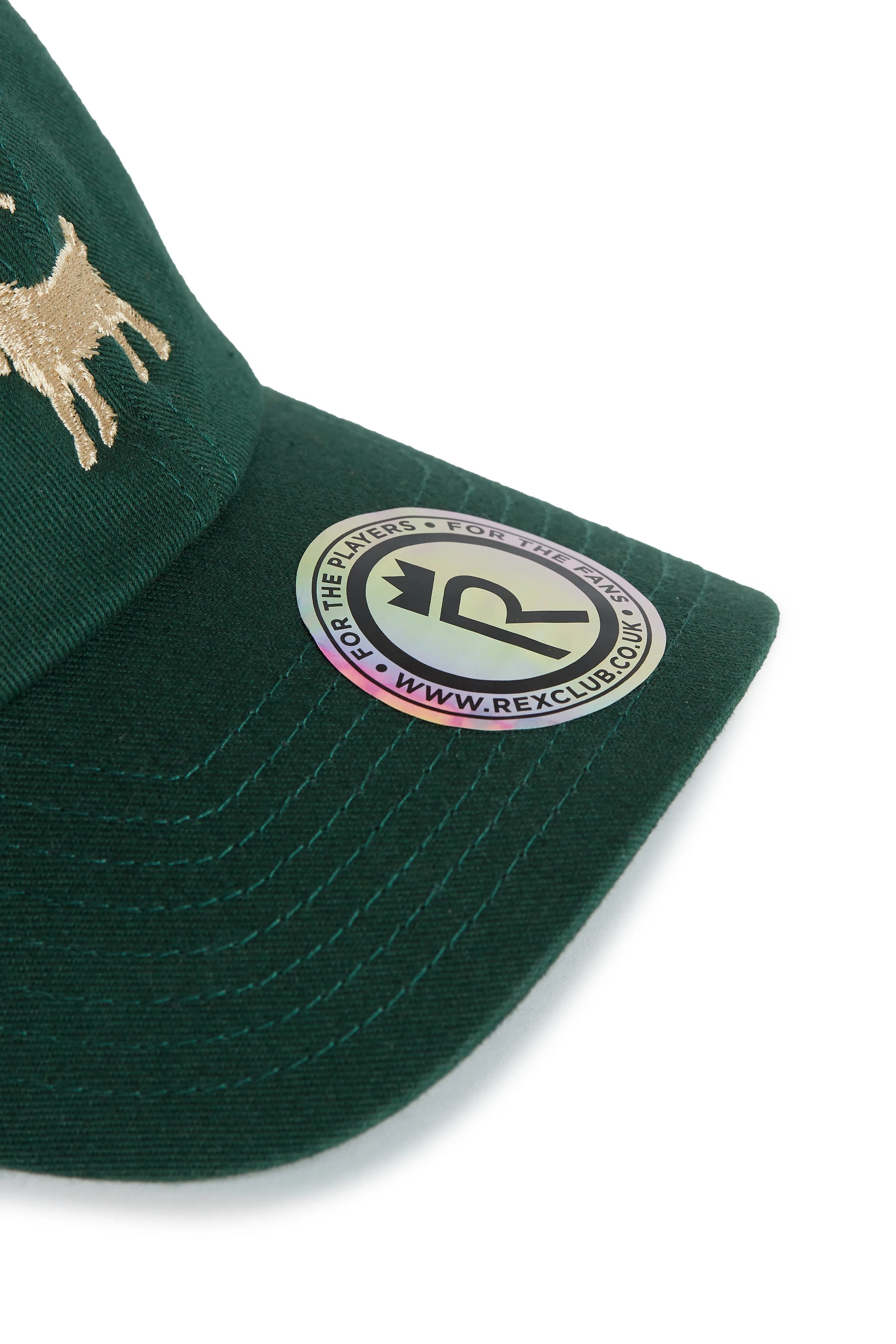 Rex Club | A close-up of the Rex Club Goat - Dark Green cap with a gold embroidered dog, a round sticker that says "FOR THE WEIRD - FOR THE WILD," a crown logo, and www.rexclub.co.uk. | Custom Caps | Custom Hats | Team Headwear | UK