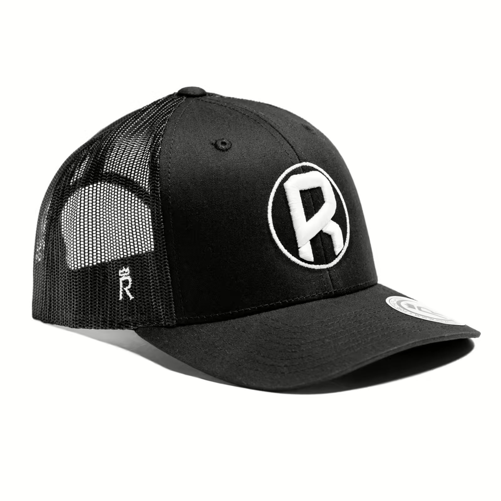 Rex Club | The Rugby Pod Trucker by Rex Club is a black mesh hat with a curved brim, bold white "R" logo on the front, and small "R" on the side mesh. It includes a flat sticker and is shown on a white background, blending classic rugby style. | Custom Caps | Custom Hats | Team Headwear | UK