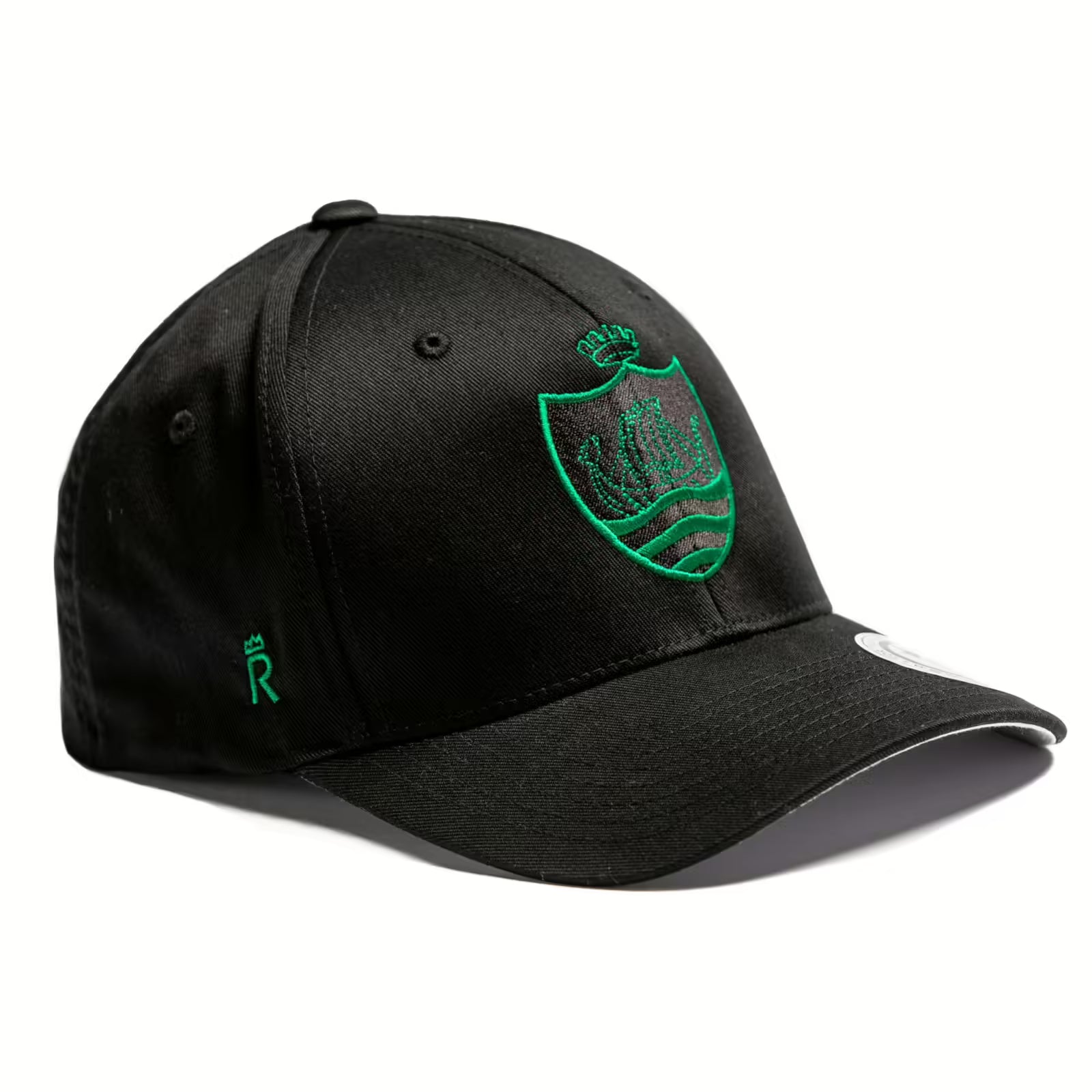 Rex Club | The Sidmouth RFC Stretch cap by Rex Club is black with a green embroidered crest (crown and waves) on the front, a small green "R" on the side, a curved brim, and a white sticker on the bill. | Custom Caps | Custom Hats | Team Headwear | UK