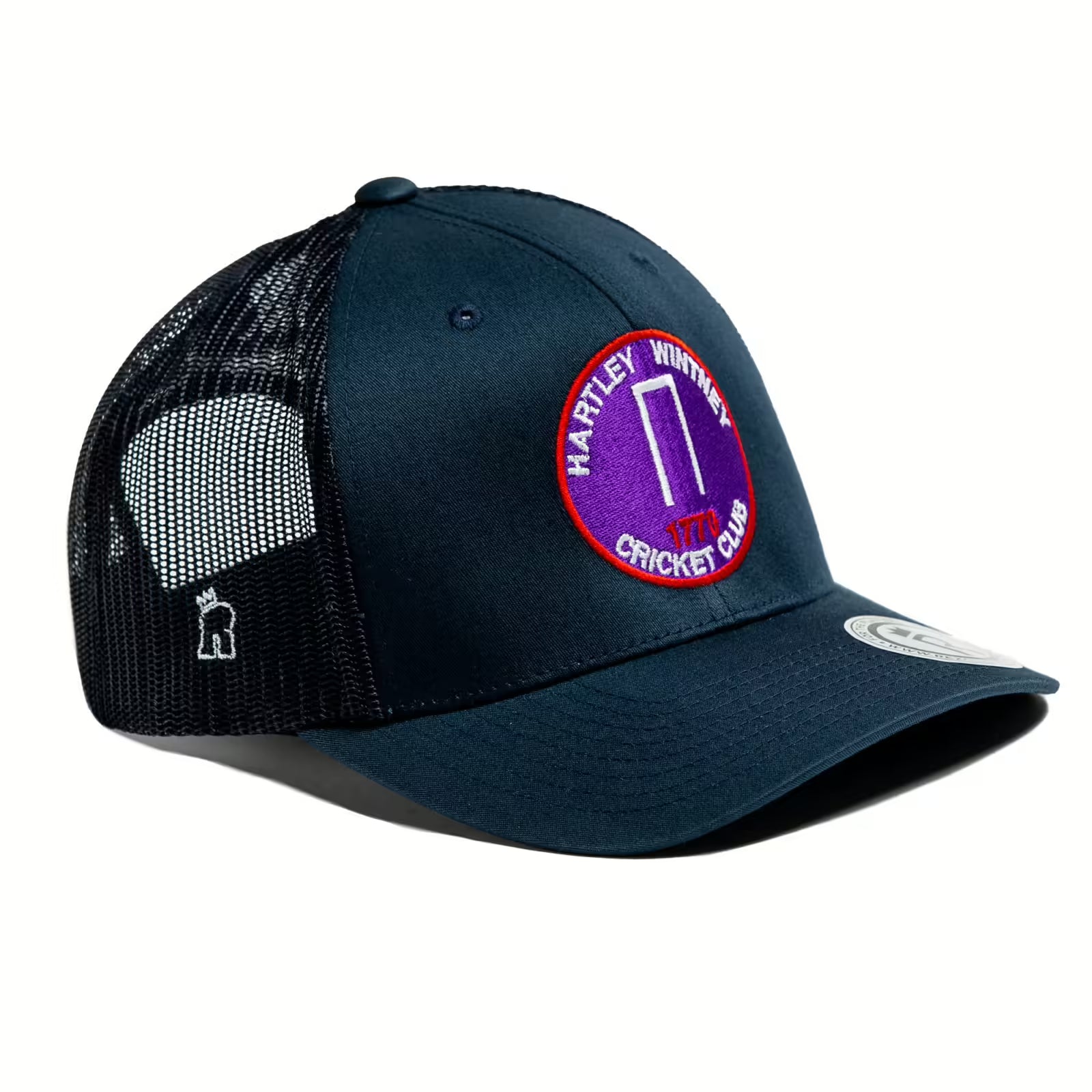 Rex Club | The Rex Club Hartley Wintney CC cap is made from cotton polyester mesh, with a circular logo patch featuring a purple wicket and a white embroidered figure on the mesh side. | Custom Caps | Custom Hats | Team Headwear | UK