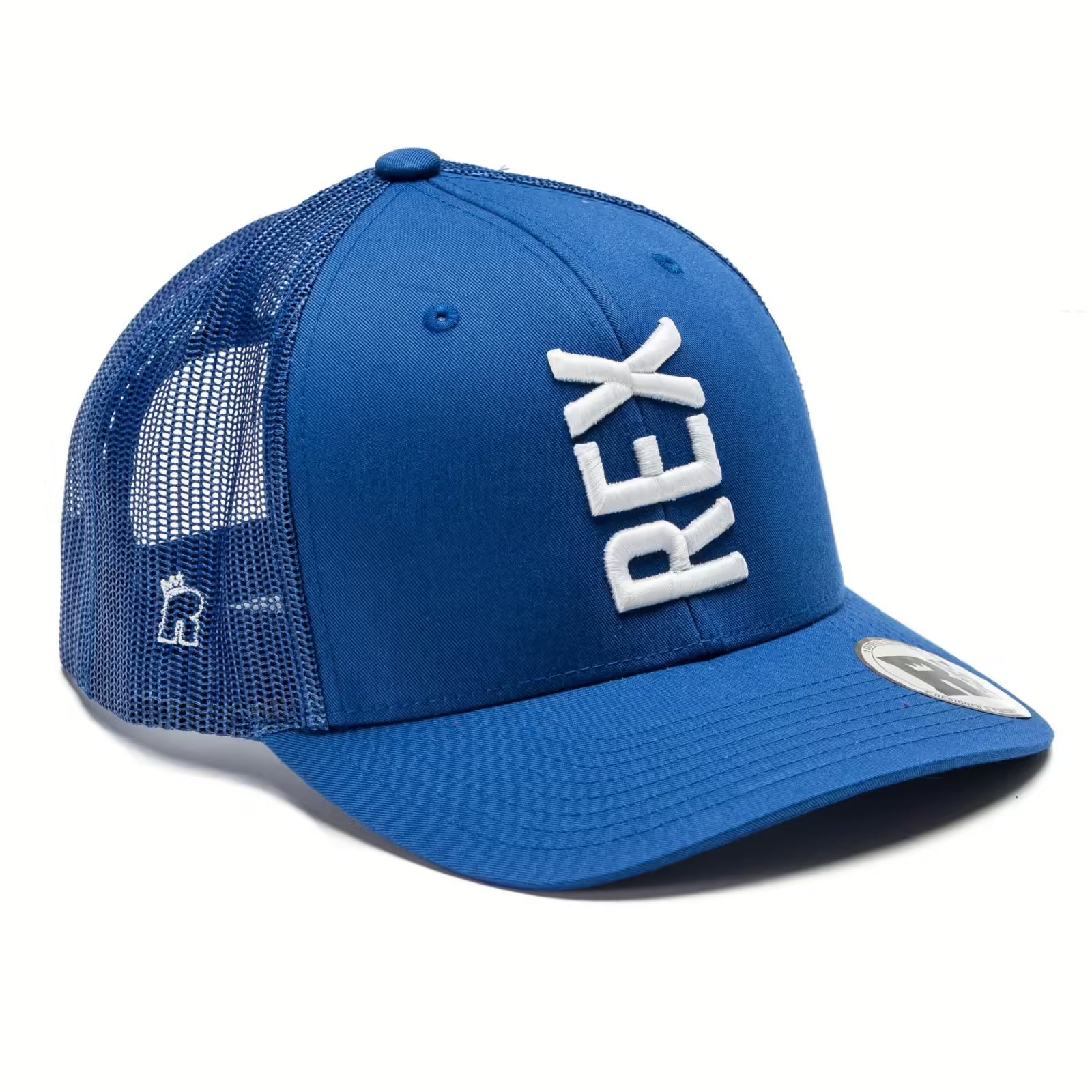 Rex Club | The Rex Club Tilted - Trucker (Royal/White) is a blue mesh-back cap with "REX" embroidered in large white vertical letters on the front, a sticker on the brim, and a small logo near the side mesh. | Custom Caps | Custom Hats | Team Headwear | UK