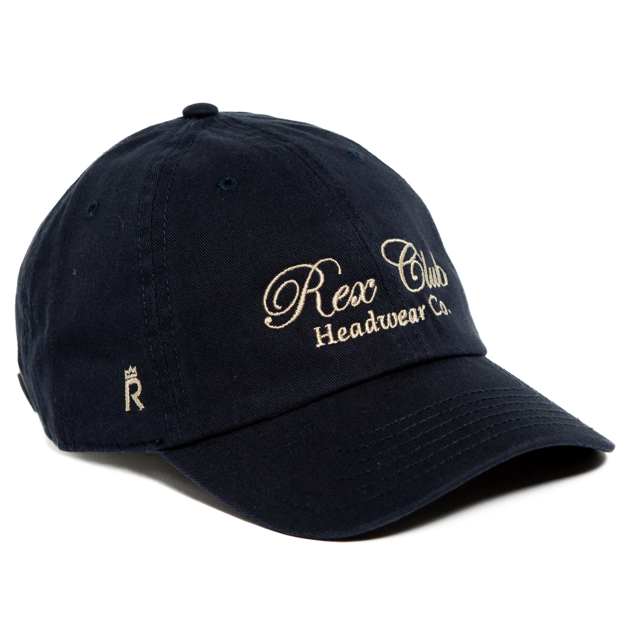 Rex Club | A black, 100% cotton Rex Club Headwear Co. cap features beige embroidered "Rex Club Headwear Co." text on the front and a small crowned "R" on the left brim. | Custom Caps | Custom Hats | Team Headwear | UK
