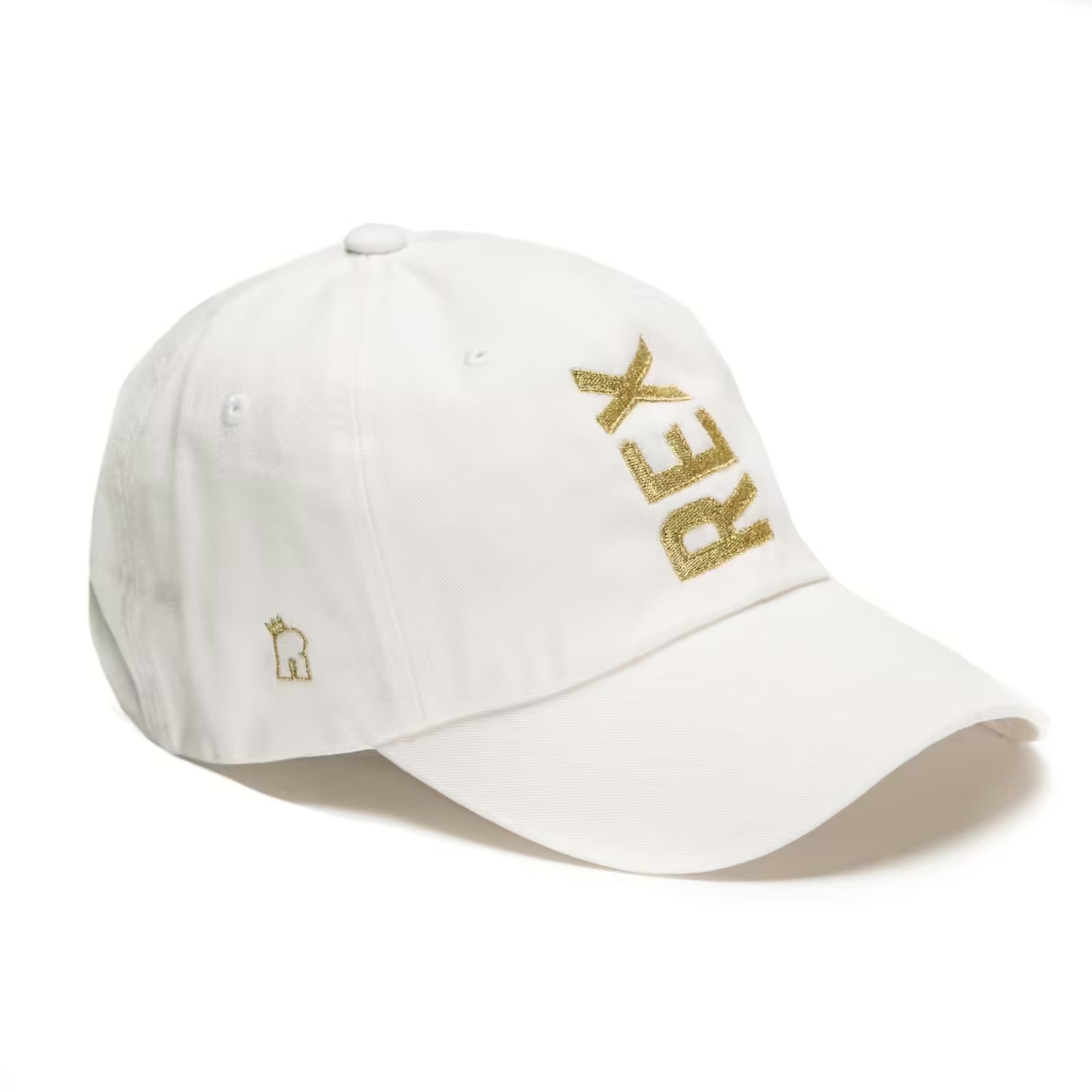 Rex Club | The Rex Club Tilted - Slouch, White is a white baseball cap by Rex Club with "REX" embroidered in gold diagonally on the front and a small gold crown logo on the side. | Custom Caps | Custom Hats | Team Headwear | UK