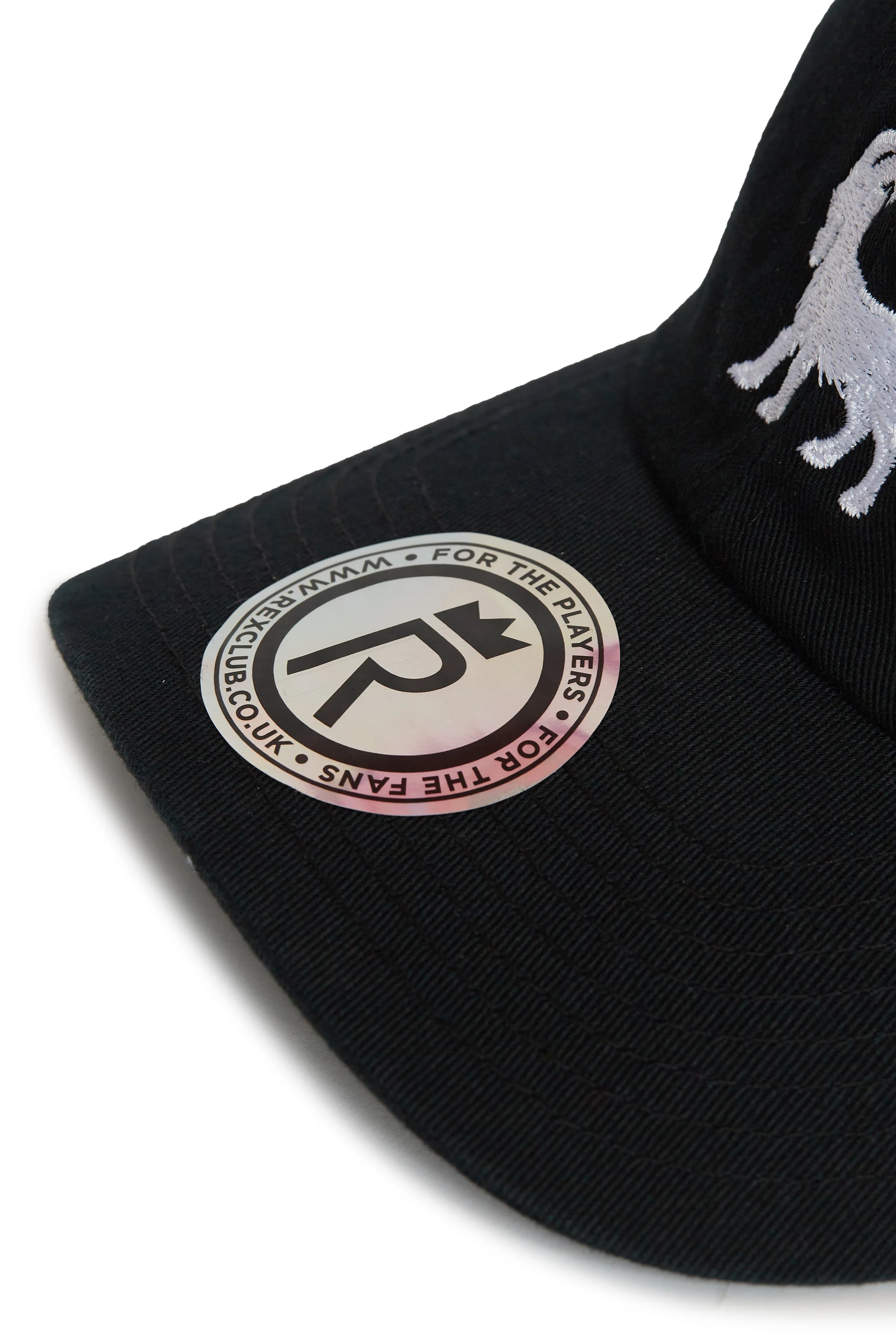 Rex Club | Close-up of the Goat - Black baseball cap by Rex Club, featuring a white embroidered design and a round sticker on the brim with the phrases "FOR THE PLAYERS, FOR THE FANS" and "WWW.RSCLUB.CO". | Custom Caps | Custom Hats | Team Headwear | UK