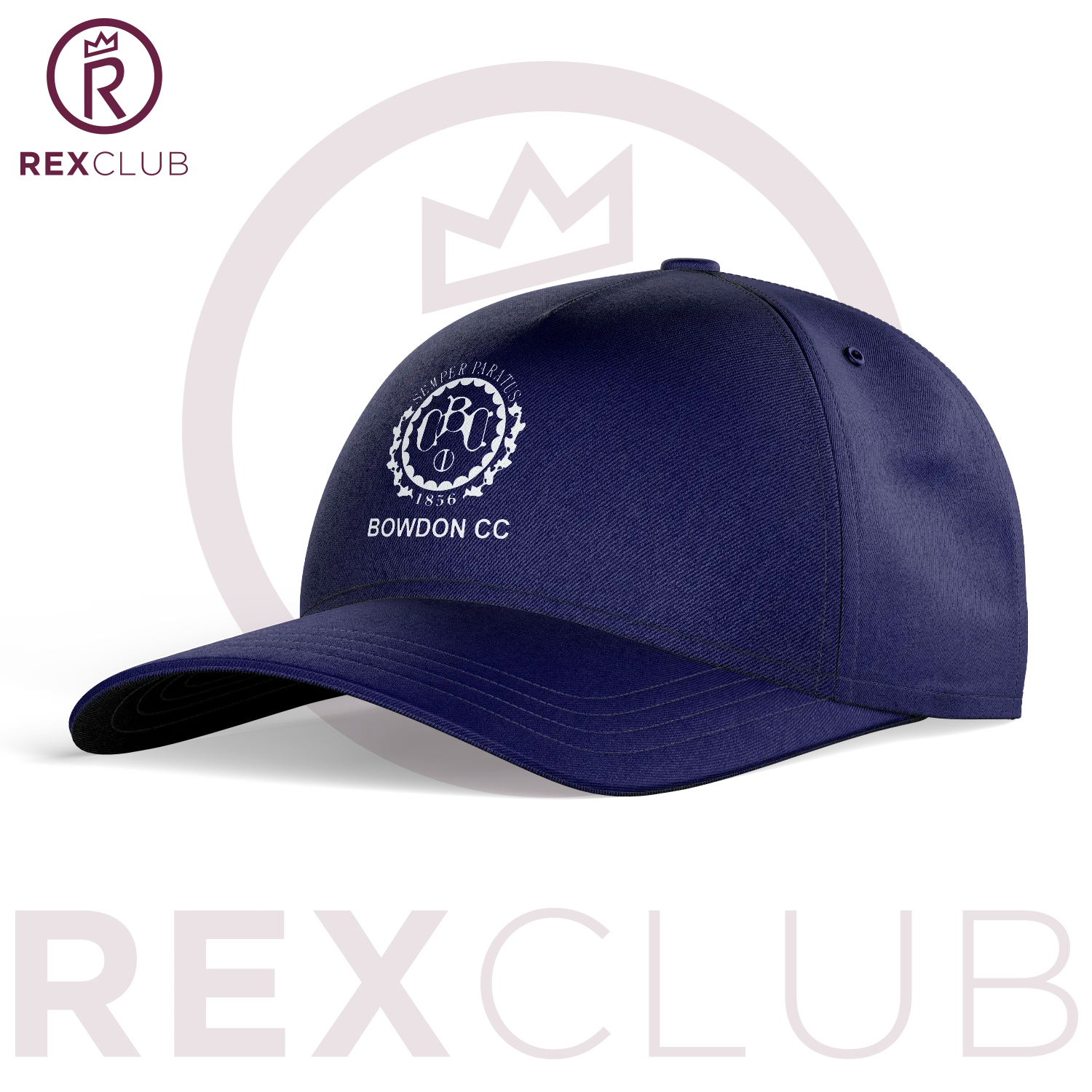 Rex Club | The Bowdon CC Slouch by Rex Club is a navy blue baseball cap featuring "BOWDON CC" and a white crest embroidered on the front, ideal for cricket club members. Shown on white with a subtle "REX CLUB" logo and crown in the background. | Custom Caps | Custom Hats | Team Headwear | UK