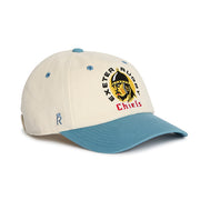 Rex Club | Introducing the Exeter Chiefs - Two Tone cap by Rex Club: a cream and blue baseball cap crafted from 100% cotton, featuring an embroidered logo of a person in a helmet alongside “Exeter Rugby Chiefs” on the front. This premium, bespoke headwear is the perfect standout accessory for true Exeter Chiefs fans. | Custom Caps | Custom Hats | Team Headwear | UK