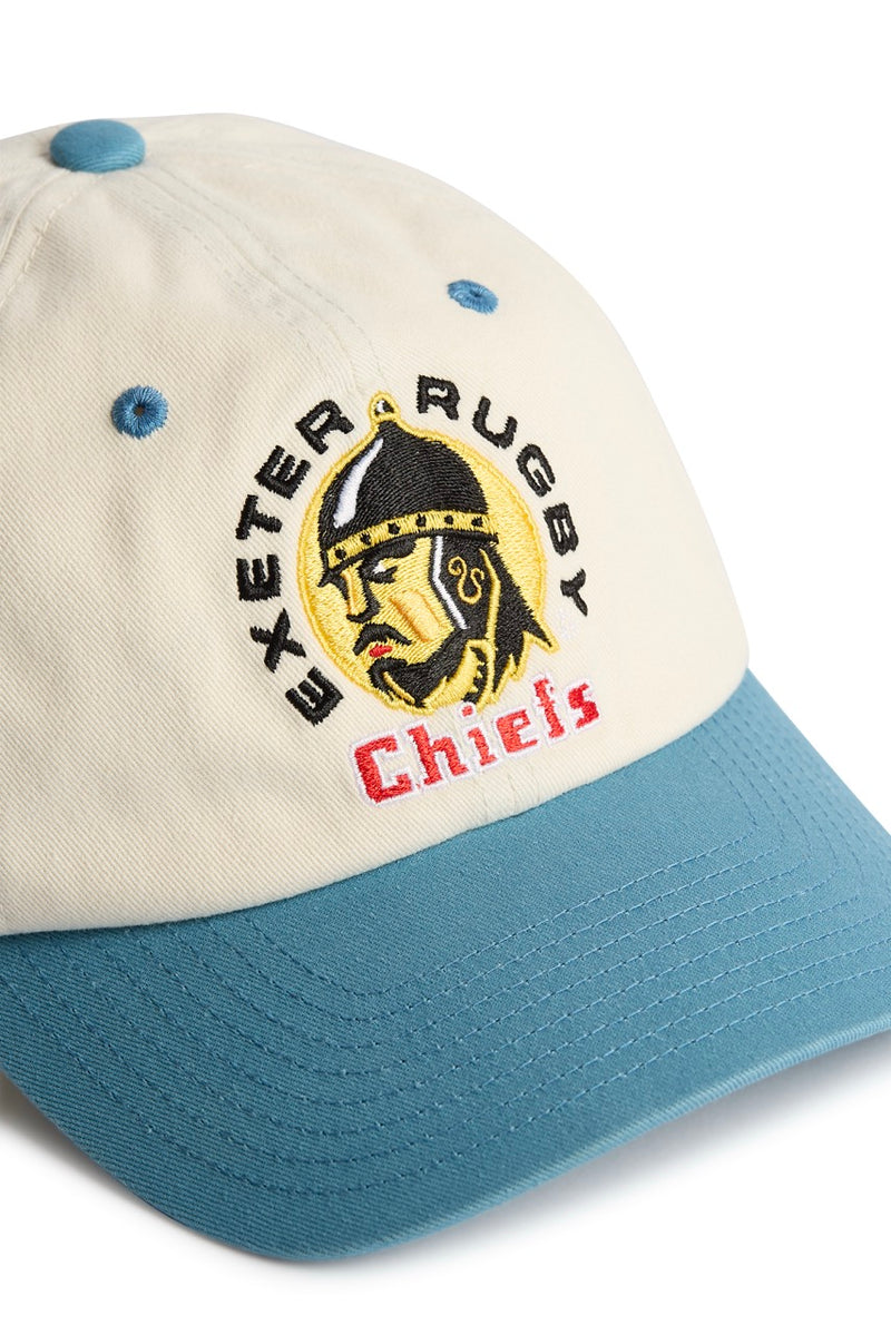 Rex Club | Introducing the Exeter Chiefs - Two Tone by Rex Club: a premium, bespoke baseball cap in cream and teal, expertly crafted from 100% cotton. This stylish headwear features an embroidered Exeter Chiefs helmet logo on the front, accented by “Exeter Rugby” in black and “Chiefs” in red beneath the image. | Custom Caps | Custom Hats | Team Headwear | UK