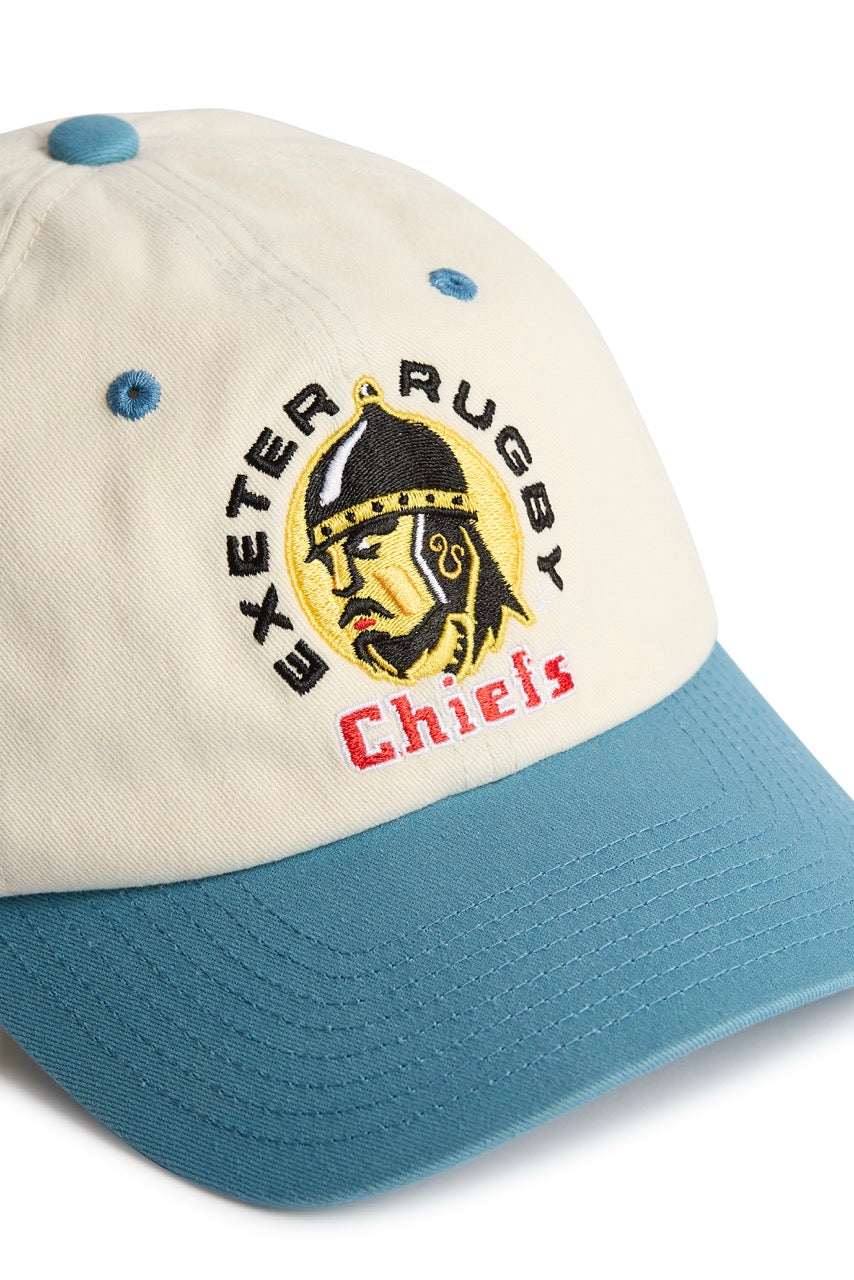 Rex Club | Introducing the Exeter Chiefs - Two Tone by Rex Club: a premium, bespoke baseball cap in cream and teal, expertly crafted from 100% cotton. This stylish headwear features an embroidered Exeter Chiefs helmet logo on the front, accented by “Exeter Rugby” in black and “Chiefs” in red beneath the image. | Custom Caps | Custom Hats | Team Headwear | UK