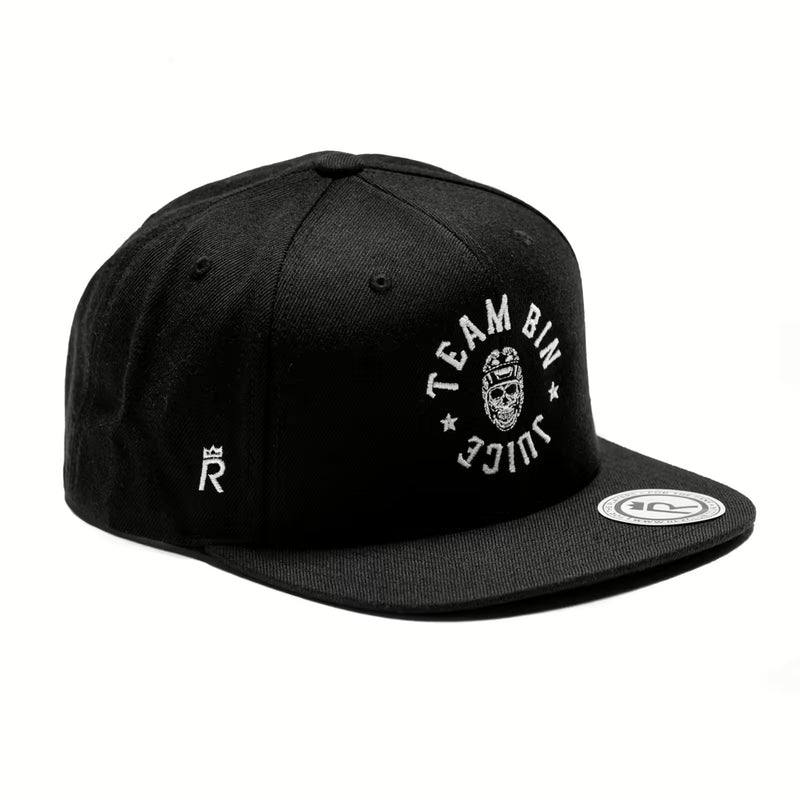 Rex Club | The Rex Club Team Bin Juice Benchwarming Snapback in black features white "TEAM BIN JUICE" embroidery and front graphic, a crowned "R" on the side, and a round white patch on the brim. | Custom Caps | Custom Hats | Team Headwear | UK