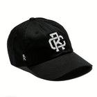 Rex Club | The Rex Club Monogram is a black cotton baseball cap with an interlocking white "DC" logo on the front and a small crowned white "R" on the side. | Custom Caps | Custom Hats | Team Headwear | UK