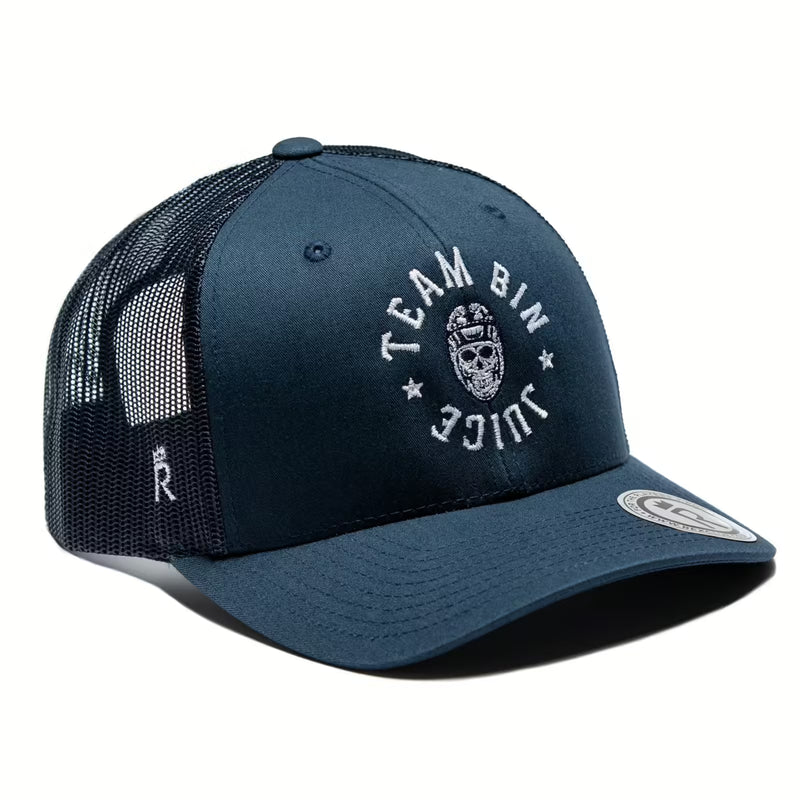 Rex Club | The Rex Club Team Bin Juice Benchwarming Trucker in navy features a black mesh back, "TEAM BIN JUICE" in white around a skull graphic on the front, a circular brim label, and a small "R" on the side. | Custom Caps | Custom Hats | Team Headwear | UK