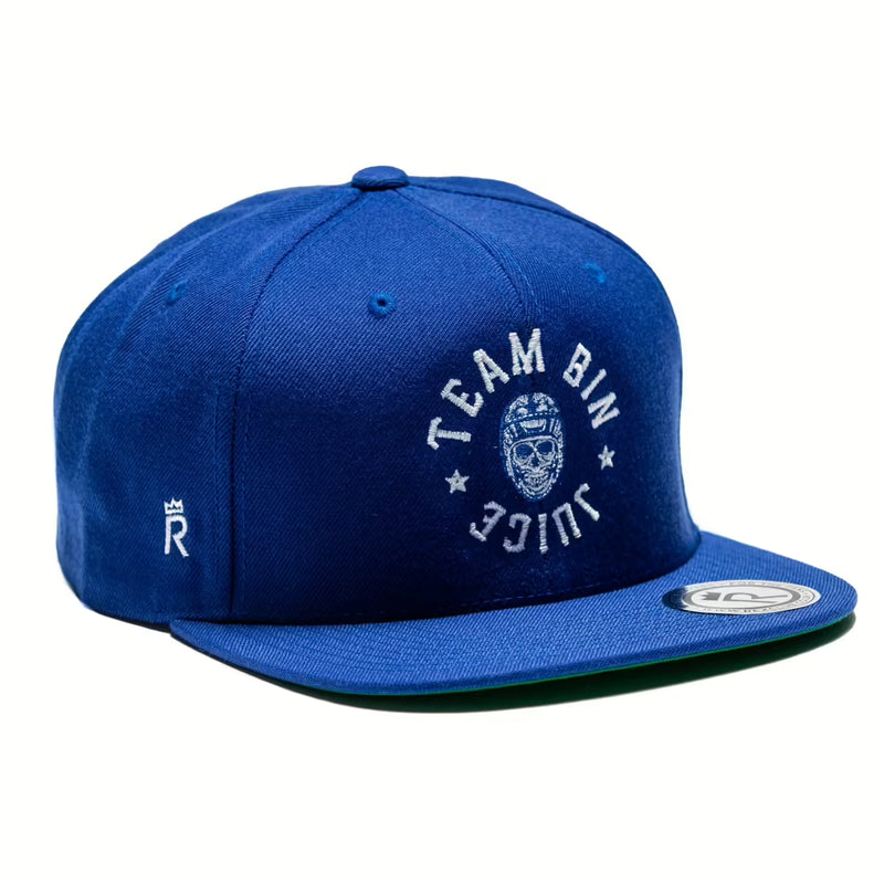 Rex Club | The Rex Club Team Bin Juice Benchwarming Snapback in royal blue features "TEAM BIN JUICE" and a small white mask embroidered on the front, with a flat brim, white logo accents on the side, and a classic brim sticker. | Custom Caps | Custom Hats | Team Headwear | UK