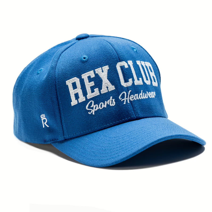 Rex Club | The Rex Club Sports Headwear Performance cap features royal blue durable acrylic, "Rex Club Sports Headwear" embroidered in white on the front, and a small white crown logo on the side. | Custom Caps | Custom Hats | Team Headwear | UK