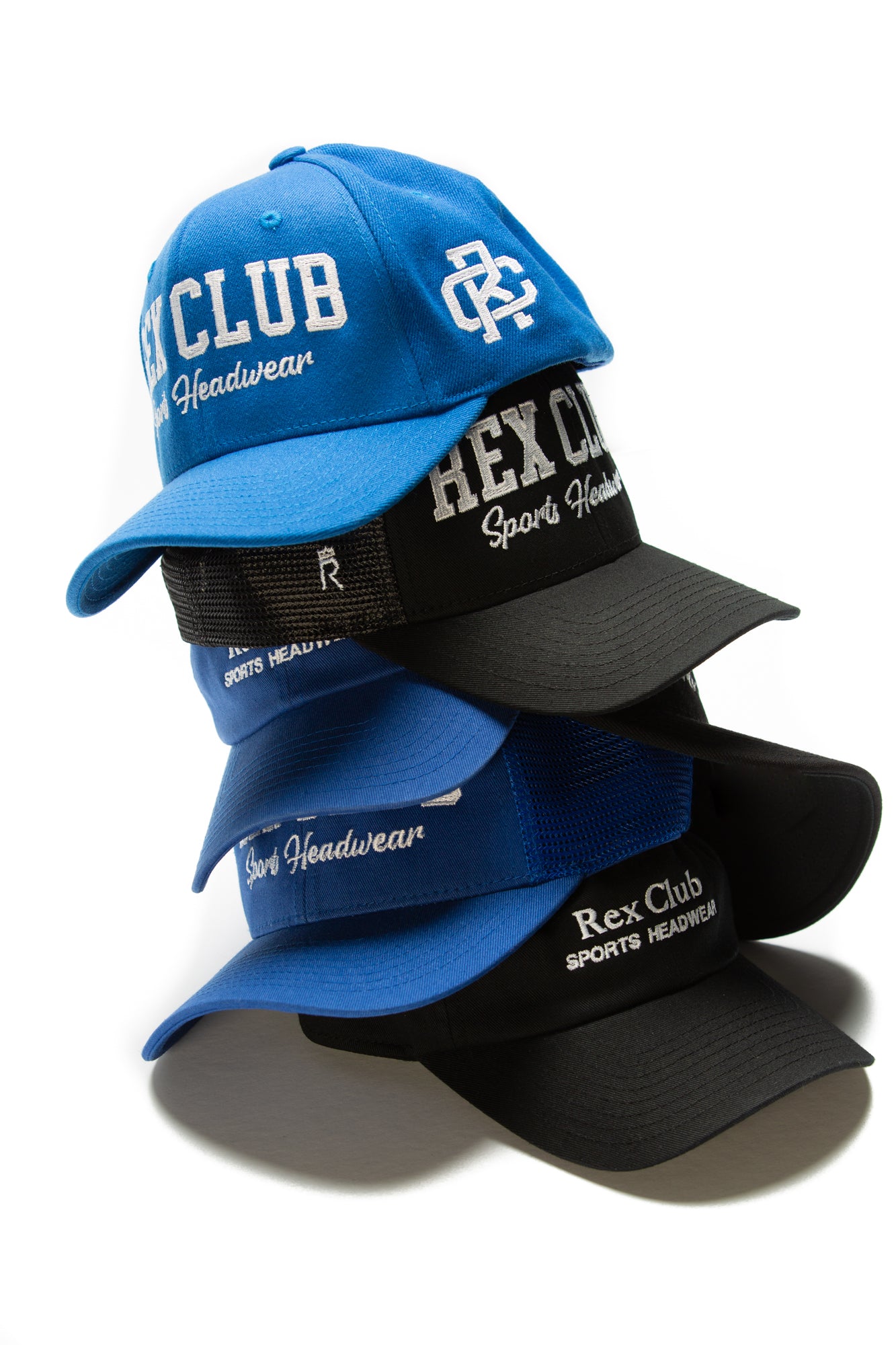 Rex Club | Four "Rex Club Sports Headwear" baseball caps—two blue and two black—are stacked vertically against a white background. Each hat has embroidered branding on the front and mesh panels on the sides. | Custom Caps | Custom Hats | Team Headwear | UK