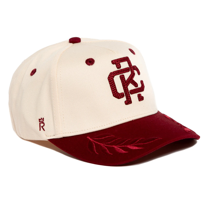 Rex Club | The Rex Club RC - Victor - Two Tone is a cream cotton baseball cap with a burgundy brim, embroidered leaf design, burgundy letters on the front, matching button and eyelets. One size fits most. | Custom Caps | Custom Hats | Team Headwear | UK