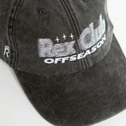 Rex Club | A close-up of the Rex Club Offseason 2025 washed black denim cap in 100% cotton, featuring white "OFFSEASON" embroidery and stylized "R" and "C" graphics with lines and stars. | Custom Caps | Custom Hats | Team Headwear | UK