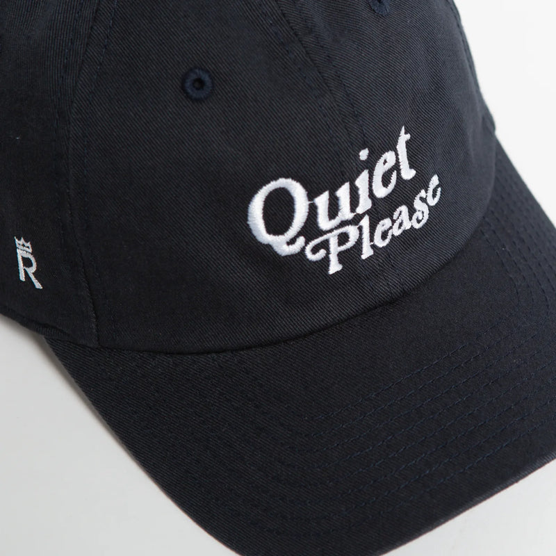 Rex Club | A navy slouch baseball cap by Rex Club, featuring "Quiet Please" embroidered in white on the front in a classic style, with a small letter "R" and crown symbol on the side. | Custom Caps | Custom Hats | Team Headwear | UK