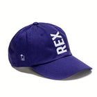Rex Club | The Rex Club Tilted - Slouch, Purple is a baseball cap with "REX" embroidered in large white letters diagonally on the front and a small white side logo. | Custom Caps | Custom Hats | Team Headwear | UK