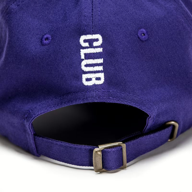 Rex Club | A close-up of the back of the Rex Club Tilted purple trucker cap by Rex Club shows "CLUB" embroidered vertically in white above the adjustable strap with brass buckle for a comfortable, customizable fit. | Custom Caps | Custom Hats | Team Headwear | UK