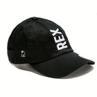 Rex Club | The Rex Club Tilted - Slouch, Black cap features "REX" embroidered vertically in bold white letters on the front and a small crowned bear design on the side. | Custom Caps | Custom Hats | Team Headwear | UK