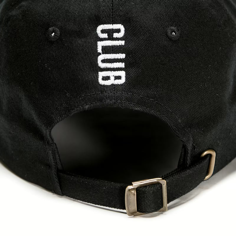 Rex Club | A close-up of the back of the Rex Club Tilted black trucker cap by Rex Club, featuring "CLUB" embroidered in white and an adjustable strap with a metal buckle for a customizable fit. | Custom Caps | Custom Hats | Team Headwear | UK