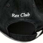 Rex Club | A close-up of the OFFSEASON 23 Slouch by Rex Club, a black 100% cotton slouch fit hat with "Rex Club" white embroidery on the back and an adjustable strap featuring a silver buckle. | Custom Caps | Custom Hats | Team Headwear | UK