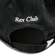 Rex Club | A close-up of the OFFSEASON 23 Slouch by Rex Club, a black 100% cotton slouch fit hat with "Rex Club" white embroidery on the back and an adjustable strap featuring a silver buckle. | Custom Caps | Custom Hats | Team Headwear | UK