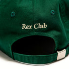 Rex Club | A close-up of the back of a green Rex Club OFFSEASON 23 Slouch cap, made from 100% cotton, with "Rex Club" embroidered in beige above the adjustable strap and metal buckle, highlighting its classic slouch fit. | Custom Caps | Custom Hats | Team Headwear | UK