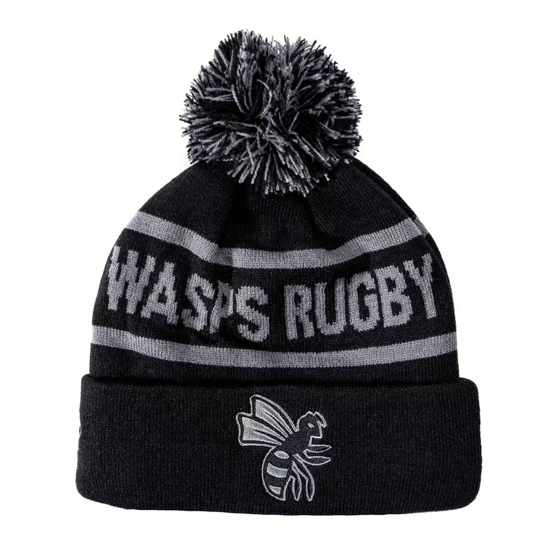 Rex Club | The Rex Club Wasps Bobble is a black and gray knit beanie with a pom-pom, "WASPS RUGBY" text, cartoon wasp logo on the cuff, and cozy fleece lining. | Custom Caps | Custom Hats | Team Headwear | UK