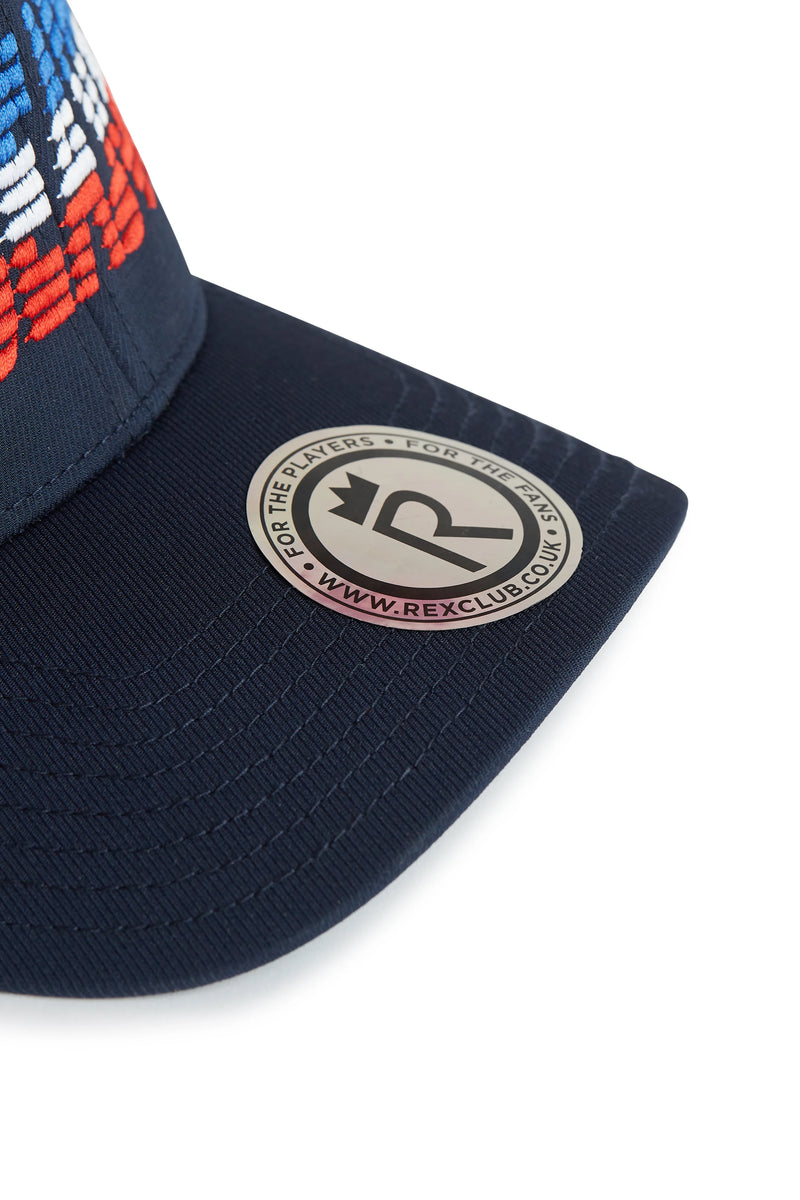 Rex Club | Close-up of the brim of the OFFSEASON 26 - Navy performance cap by Rex Club, featuring a round metallic sticker that reads "FOR THE PLAYERS STOP PLAY HARD" and "WWW.REXCLUB.CO" encircling a stylized "R" logo—ideal for fans of stylish Offseason caps. | Custom Caps | Custom Hats | Team Headwear | UK