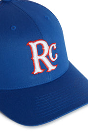 Rex Club | The RC 26 Trucker by Rex Club is a blue hat with white "RC" letters outlined in red on the front, designed in a classic sport team monogram style. | Custom Caps | Custom Hats | Team Headwear | UK