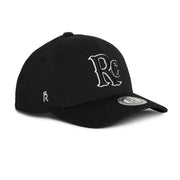 Rex Club | The RC 26 Performance cap by Rex Club is a black baseball hat with bold white "RC" monogram embroidery, a crown-topped "R" on the side, and a round sticker on the curved brim—ideal for sports teams or classic style enthusiasts. | Custom Caps | Custom Hats | Team Headwear | UK