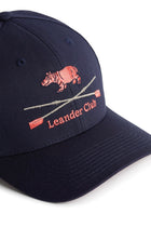 Rex Club | This premium bespoke navy blue baseball cap by Rex Club features an embroidered pink hippopotamus above two crossed oars and the words “Leander Club” in pink stitching on the front—a stylish nod to one of the world’s most renowned rowing clubs. | Custom Caps | Custom Hats | Team Headwear | UK