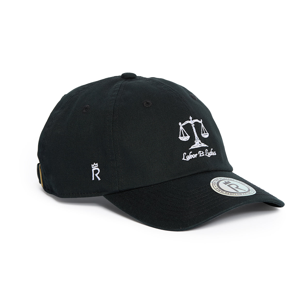 Rex Club | The Labor Et Ludus cap by Rex Club is a black baseball hat featuring an embroidered scales of justice and “Labor Et Ludus” on the front, a small crowned “R” on the side, and a round silver sticker on the brim. Made from 100% cotton, this one-size-fits-most cap delivers comfort and style for everyday work or play. | Custom Caps | Custom Hats | Team Headwear | UK