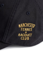Rex Club | Close-up of the MTRC - Navy cap by Rex Club, featuring yellow embroidery that reads “Manchester Tennis & Racquet Club.” The stitching is crisp, and the fabric’s texture is clearly visible, highlighting the quality craftsmanship of this official club merchandise. | Custom Caps | Custom Hats | Team Headwear | UK