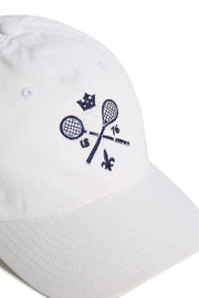 Rex Club | The Rex Club MTRC – White baseball cap features an embroidered design of two crossed tennis rackets, a small crown, “1876,” and a fleur-de-lis in navy blue on the front—a stylish piece of club merchandise perfect for fans of classic sportswear or collectors of Manchester Tennis & Racquets Club caps. | Custom Caps | Custom Hats | Team Headwear | UK