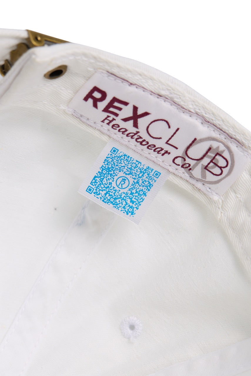 Rex Club | Close-up of the inside of the MTRC – White cap by Rex Club, a popular club merchandise item, featuring a “REX CLUB Headwear co.” label and a blue QR code tag with a small icon next to the metal adjustment buckle. | Custom Caps | Custom Hats | Team Headwear | UK