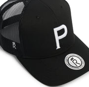 Rex Club | The Rex Club Cornish Pirates - P Trucker is a stylish black cap inspired by rugby, featuring a white embroidered "P" on the front and a round sticker with "R" plus "FOR THE PLAYERS • FOR THE NEXT • WWW.REXCLUB.COM". | Custom Caps | Custom Hats | Team Headwear | UK
