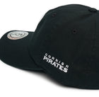 Rex Club | The Rex Club Cornish Pirates - P Slouch is a black baseball cap featuring "Cornish Pirates" white embroidery on the side and a round logo patch on the brim. | Custom Caps | Custom Hats | Team Headwear | UK