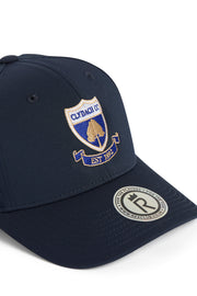 Rex Club | The Clydach CC Stretch by Rex Club is a classic navy blue adjustable cap, featuring an embroidered Claddagh GAA crest and “EST 1932” text in gold and blue, plus a silver sticker on the brim. Made from a polyester-cotton-spandex blend, this hat offers comfort and style—perfect for everyday wear. | Custom Caps | Custom Hats | Team Headwear | UK