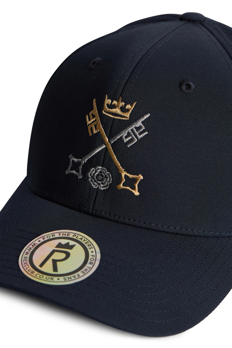 Rex Club | The Rex Club St Peter's York cap is a black baseball hat featuring gold crown, crossed keys, and white rose embroidery inspired by St Peter's School in York—the world's third-oldest school. A round "For the Players" sticker decorates the brim. | Custom Caps | Custom Hats | Team Headwear | UK
