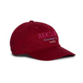 Rex Club | Introducing the “In the details - Tyrian” cap by Rex Club—a maroon slouch baseball cap crafted from 100% cotton, featuring a curved brim and visible seams on the crown. The front showcases “REX CLUB Headwear Co. MMXXIII” embroidered in vibrant pink and purple, making this comfortable hat a standout piece for your summer collection. | Custom Caps | Custom Hats | Team Headwear | UK