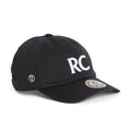 Rex Club | A navy slouch cap from Rex Club, crafted from 100% cotton, features bold white “RC” letters on the front, a round logo patch on the brim, and smaller embroidered symbols on the side for added detail. The model is named RC 3d 26. | Custom Caps | Custom Hats | Team Headwear | UK