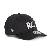 Rex Club | A navy slouch cap from Rex Club, crafted from 100% cotton, features bold white “RC” letters on the front, a round logo patch on the brim, and smaller embroidered symbols on the side for added detail. The model is named RC 3d 26. | Custom Caps | Custom Hats | Team Headwear | UK