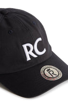 Rex Club | A navy slouch cap by Rex Club, made from 100% cotton, featuring large white “RC” letters embroidered on the front and a round “Rex Club” sticker on the brim. Product name: RC 3d 26 - Navy. | Custom Caps | Custom Hats | Team Headwear | UK
