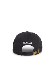 Rex Club | A navy embroidered cap viewed from the back, featuring the words “REX CLUB” stitched in white above an adjustable strap with a brass buckle. This 100% cotton slouch cap from Rex Club offers both comfort and classic style. | Custom Caps | Custom Hats | Team Headwear | UK