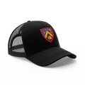 Rex Club | The Rex Club Trinity Academicals Trucker is a black mesh trucker hat with a vibrant shield crest in yellow, red, and blue on the front panel, shown against a white background. | Custom Caps | Custom Hats | Team Headwear | UK