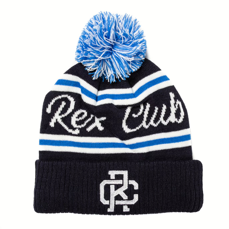 Rex Club | The Rex Club Bobble Hat by Rex Club is a navy blue 100% acrylic beanie with white and blue stripes, a blue and white pom-pom, "Rex Club" across the front, and interlocking "RC" embroidered on the folded brim. | Custom Caps | Custom Hats | Team Headwear | UK