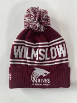 Rex Club | The Wilmslow Wolves RUFC Bobble Hat is maroon and white, featuring a pom-pom on top. It prominently displays the text "WILMSLOW" in large letters, along with "WILMSLOW RUGBY" accompanied by a wolf logo below. | Custom Caps | Custom Hats | Team Headwear | UK